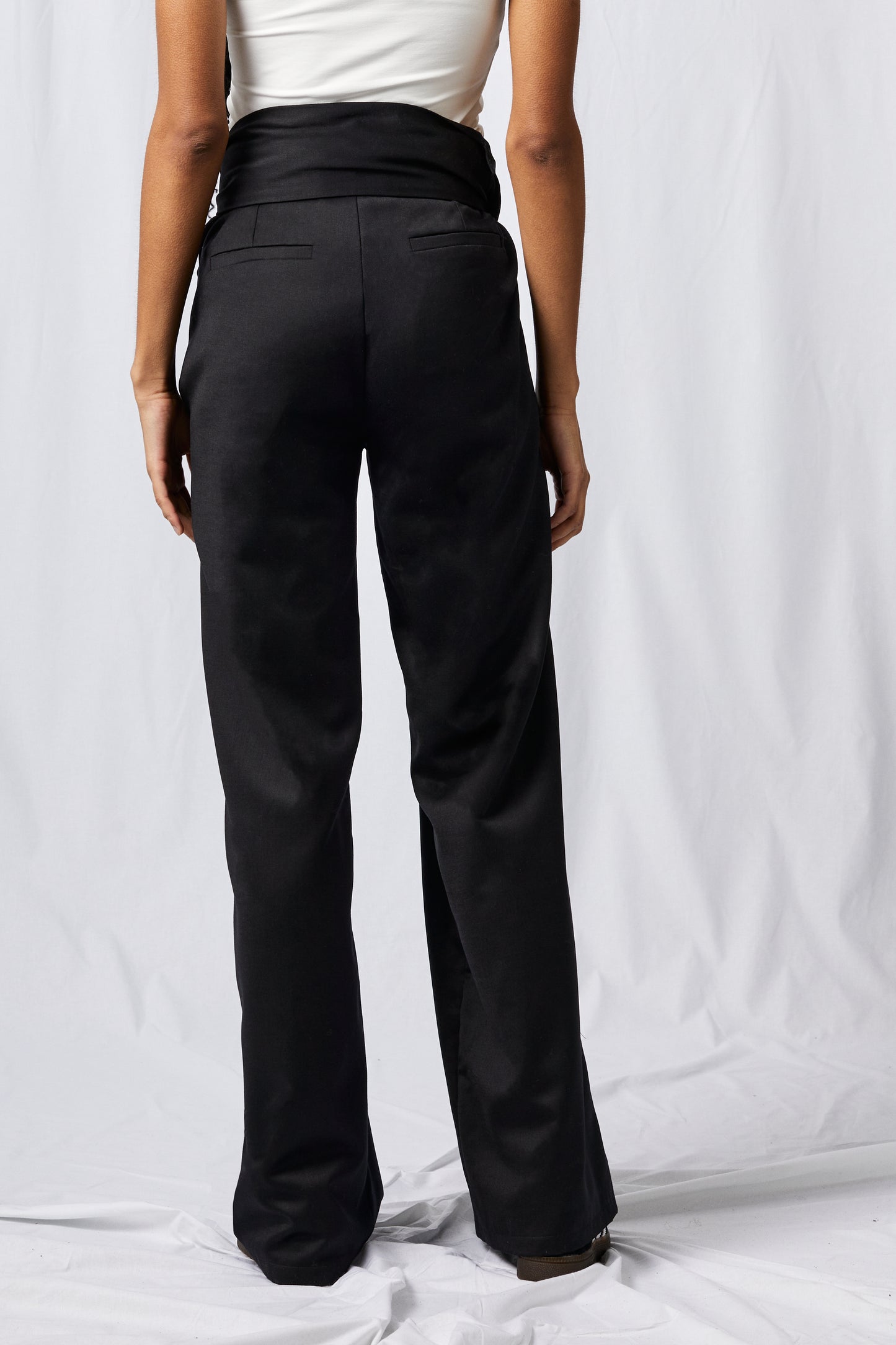 black wool pants on white background