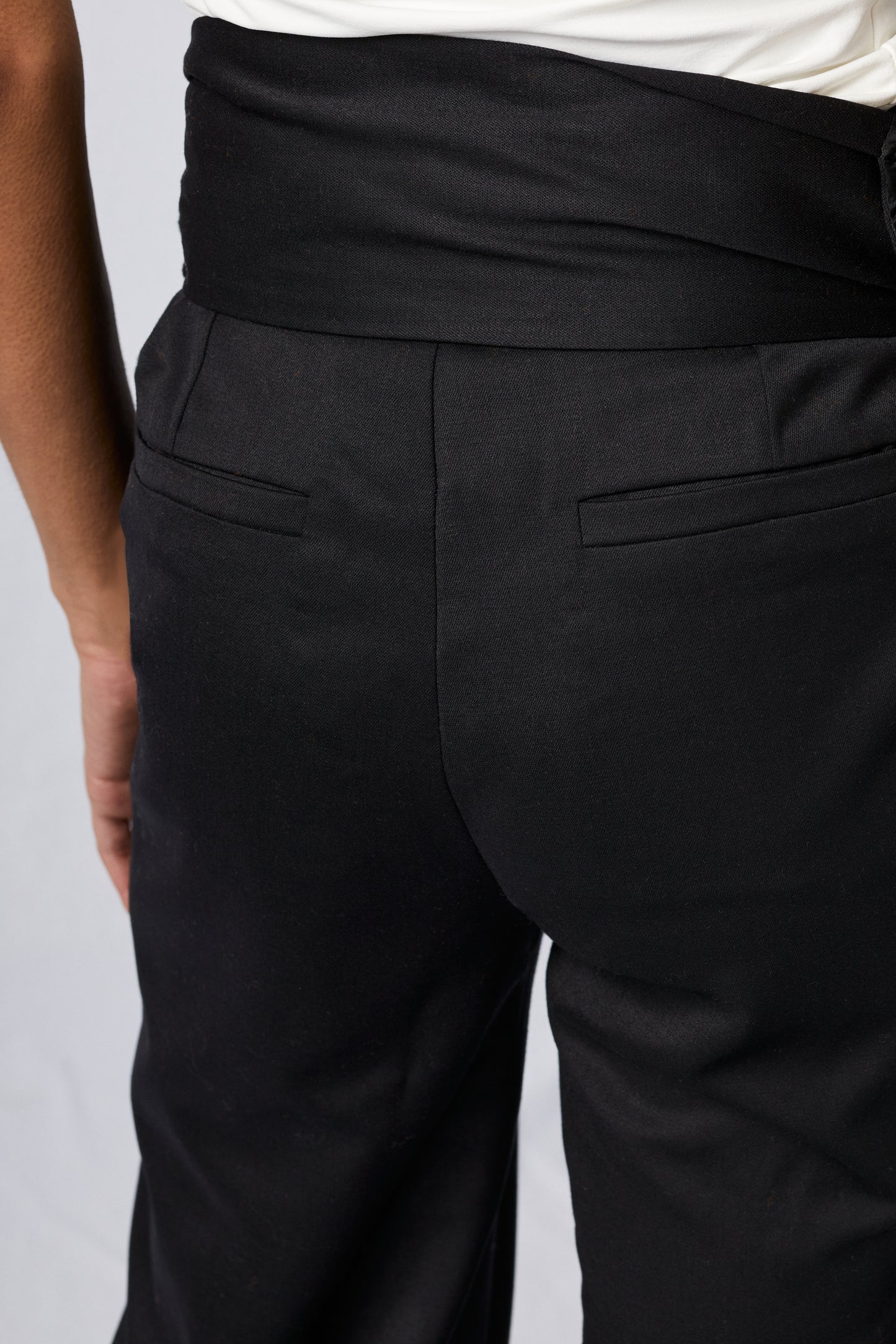 black wool pants on white background